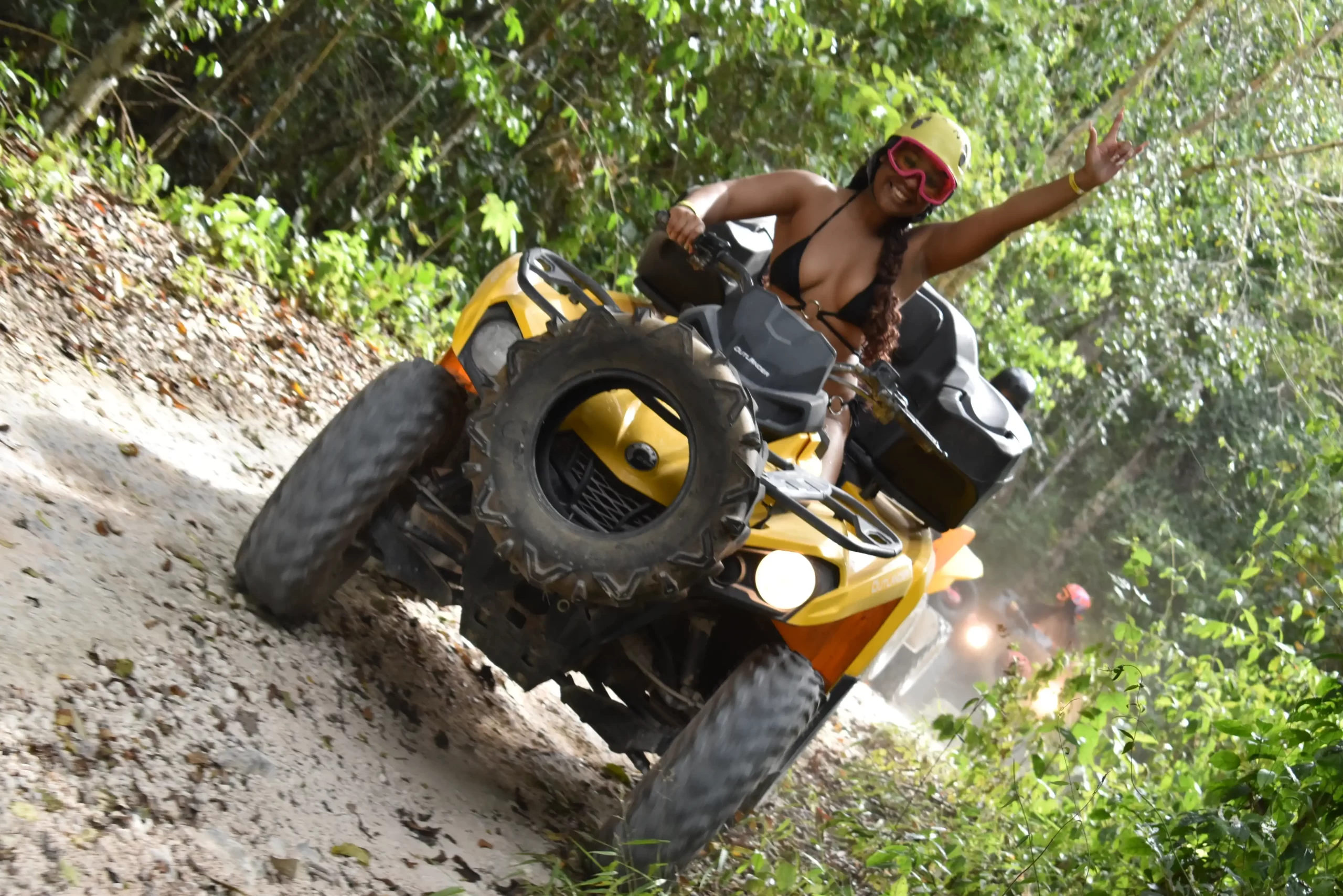 Tourist riding an ATV through Cancun’s jungle, exploring the wild terrain.