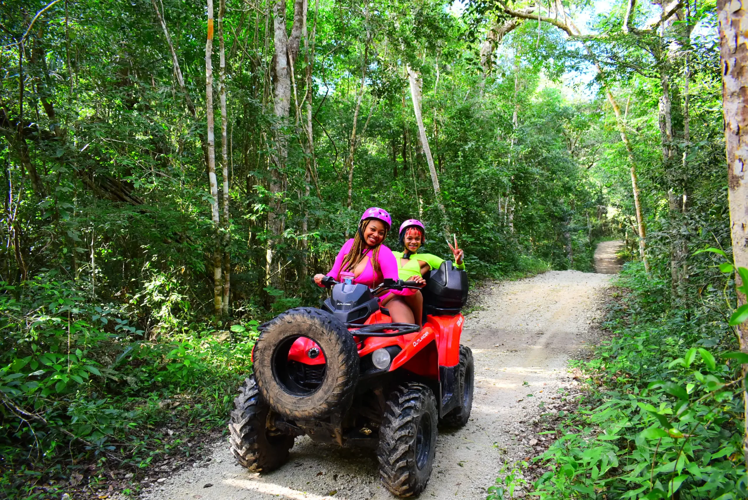 ATV rider exploring Cancun jungle trails with a cenote swim.