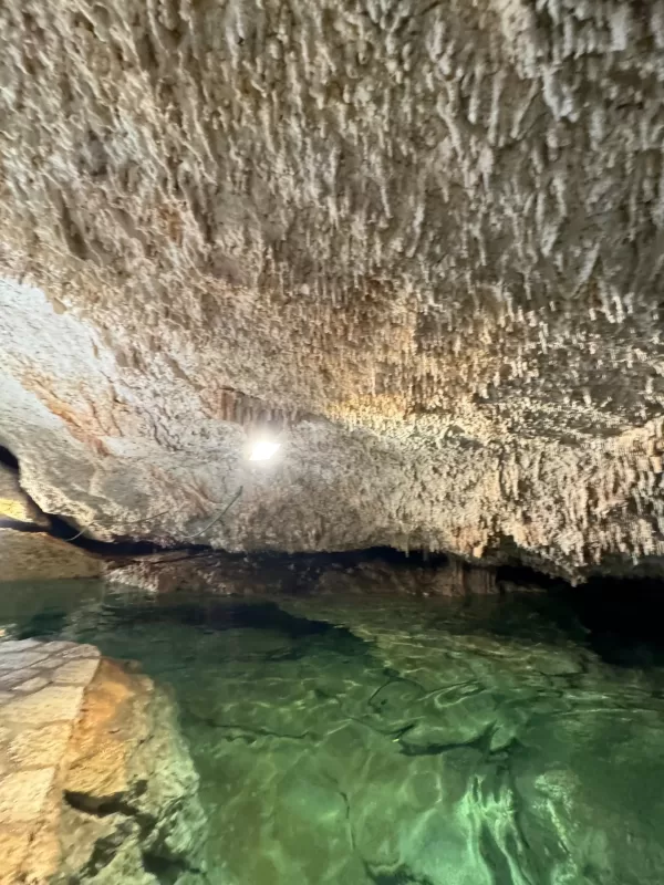 Stunning underground cenote with crystal-clear turquoise water in Cancun.