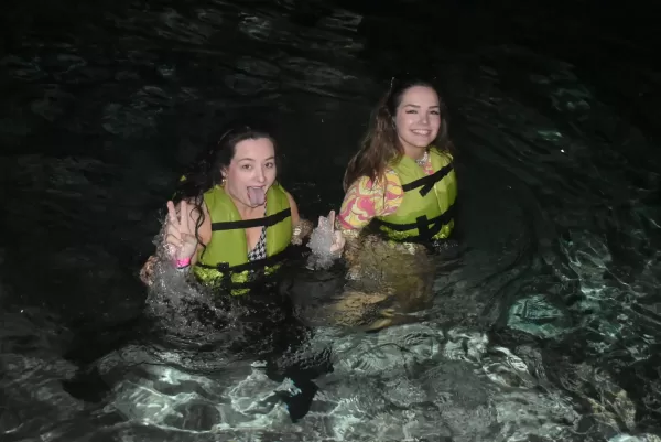 Two women enjoying a refreshing swim in a Cancun cenote