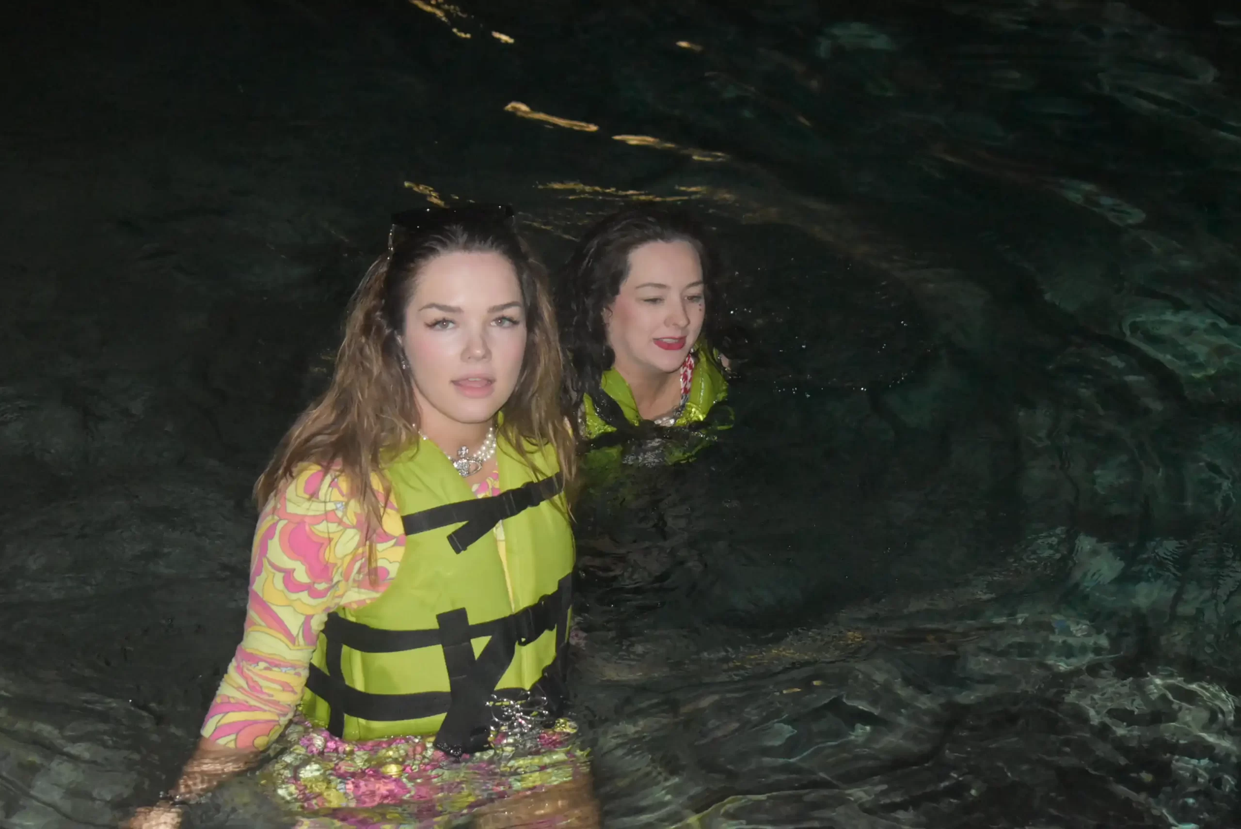 Two women swimming in a hidden cenote in Cancun