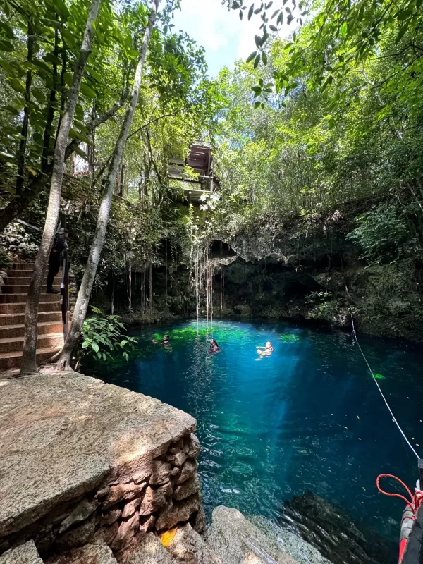 Tourists swimming in a cenote during a jungle adventure in Cancun