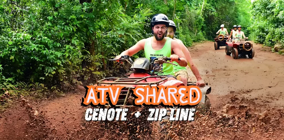 Man and woman on a shared ATV ride through a muddy jungle trail