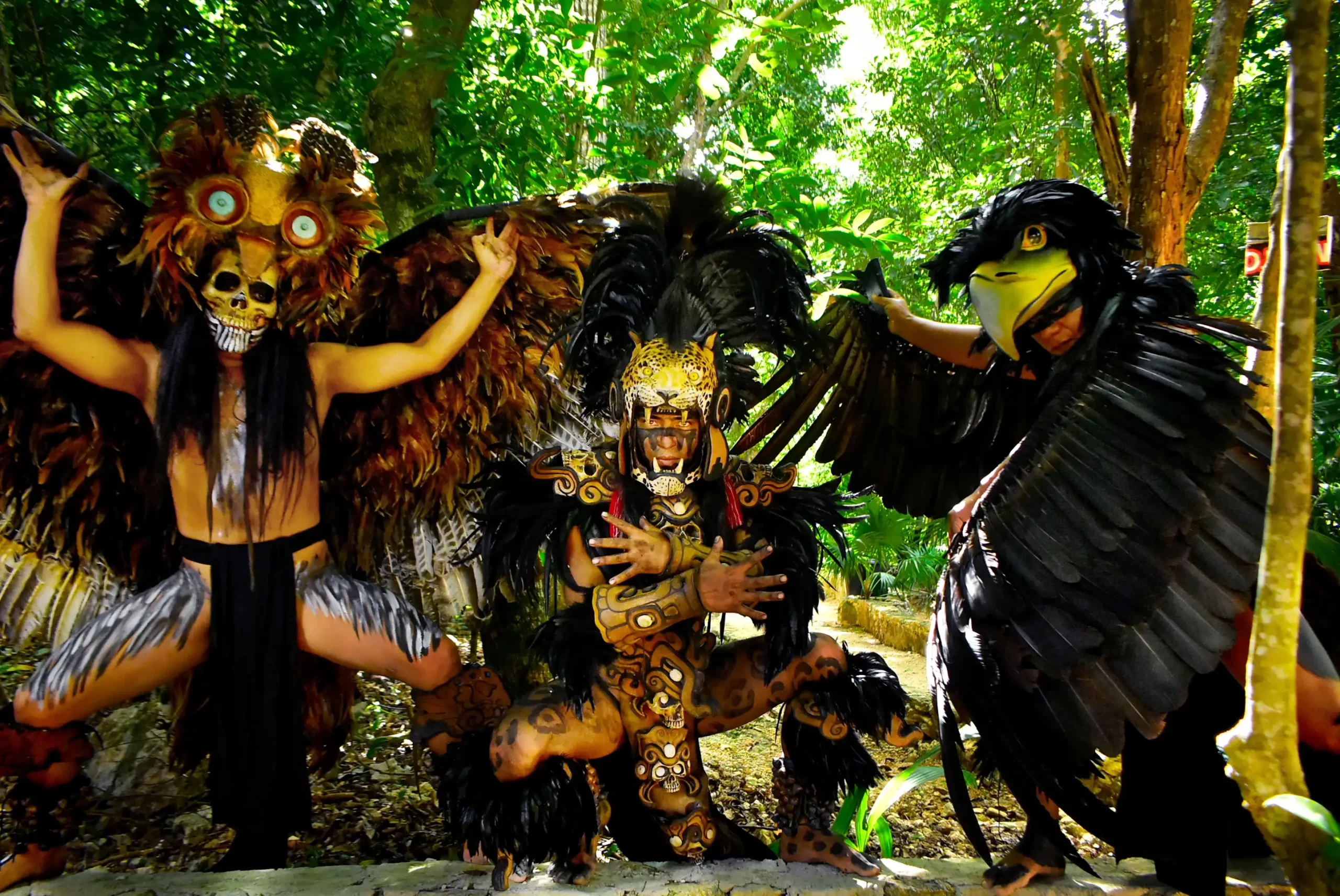 Group of performers in intricate jungle creature costumes posing together.