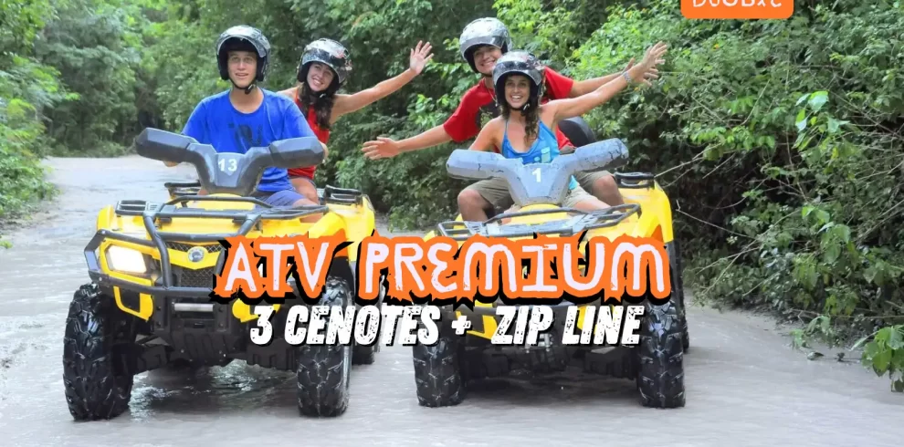 Two couples riding yellow ATVs through a jungle trail, enjoying the ATV Premium Tour with three cenotes and a zip line in Cancun.