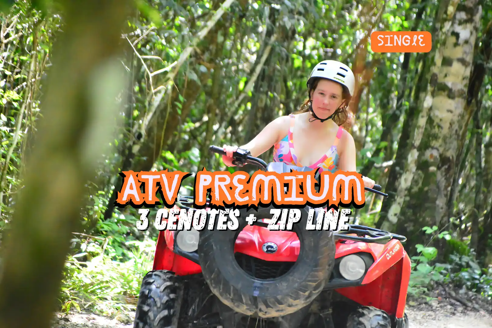 Woman in a floral swimsuit riding a red ATV through a lush jungle on the Single ATV Premium Tour in Cancun.
